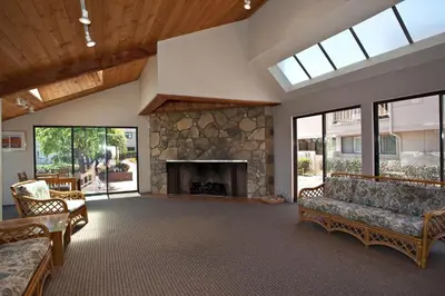a large living room with a stone fireplace at Above the Waves - SUR116 in Solana Beach