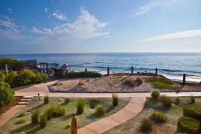a view of a garden with the ocean in the background at Serenity By The Sea - SBTC202 in Solana Beach