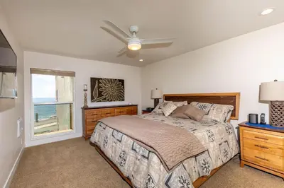 a bedroom with a bed and a ceiling fan at Serenity By The Sea - SBTC202 in Solana Beach