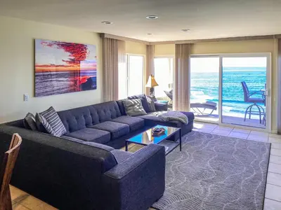 a living room with a blue couch and a table at Sunnyside Up! - SBTC213 in Solana Beach