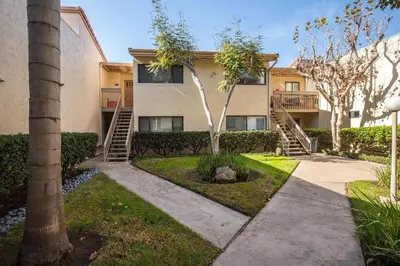 a apartment building with stairs and trees in a yard at Sunnyside Up! - SBTC213 in Solana Beach