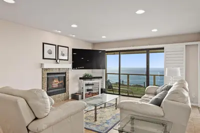 a living room with two couches and a fireplace at Bella Vista - SUR111 in Solana Beach