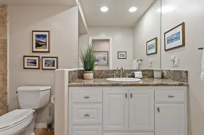 a bathroom with a white toilet and a sink at Bella Vista - SUR111 in Solana Beach