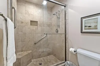 a shower with a glass door in a bathroom at Bella Vista - SUR111 in Solana Beach