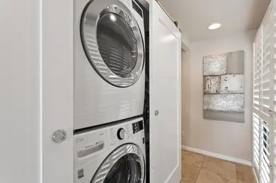 a washing machine and a washer and dryer in a room at Bella Vista - SUR111 in Solana Beach