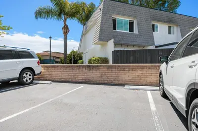 two cars parked in a parking lot in front of a house at Keepin' It Real - SB851VA in Solana Beach
