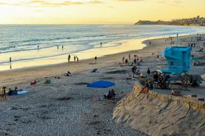a group of people on a beach at sunset at Keepin' It Real - SB851VA in Solana Beach