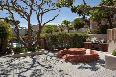 a patio with a bench and a tree at Let the Sea Set you Free SUR35 in Solana Beach