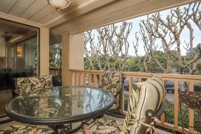 a screened in porch with a glass table and chairs at Adventure Awaits - SUR15 in Solana Beach