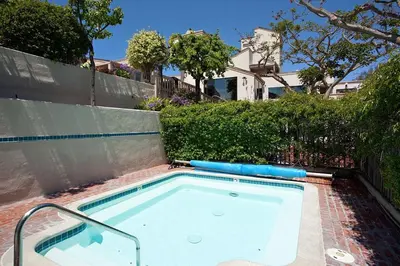 a swimming pool in front of a fence at Adventure Awaits - SUR15 in Solana Beach