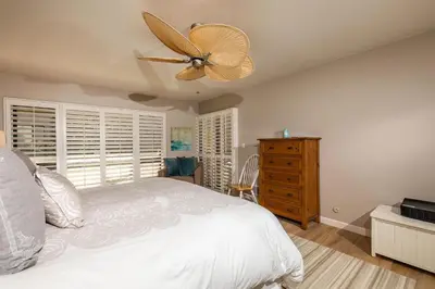 a bedroom with a white bed and a ceiling fan at High Tides & Good Vibes SUR169 in Solana Beach