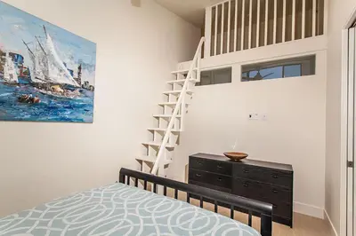 a bedroom with a bunk bed and a ladder on the wall at Paradise Awaits - SUR182 in Solana Beach
