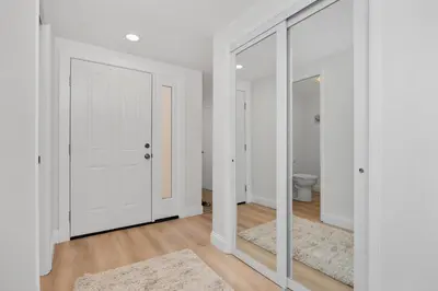 a white room with a mirror and a toilet at Tranquil Living - SUR4 in Solana Beach