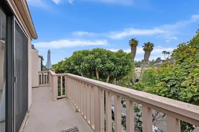 a balcony of a house with palm trees at Tranquil Living - SUR4 in Solana Beach