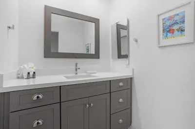 a bathroom with a sink and two mirrors at Sun, Sand, & Vitamin Sea - SUR5 in Solana Beach