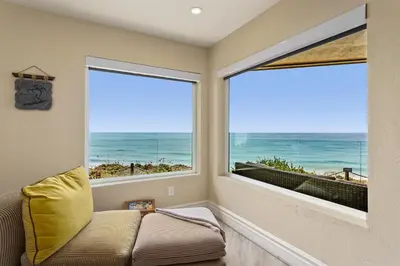 a living room with two large windows and a couch at Relax & Renew - SONG8 in Solana Beach