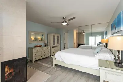 a bedroom with a bed and a fireplace at Relax & Renew - SONG8 in Solana Beach