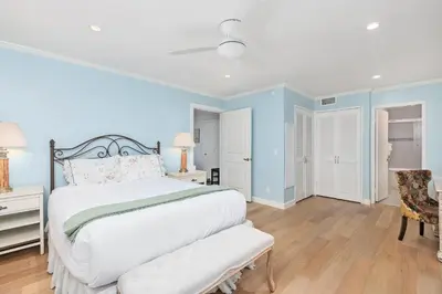 a bedroom with a white bed and a chair at Sea Forever - DMST3536 in Solana Beach