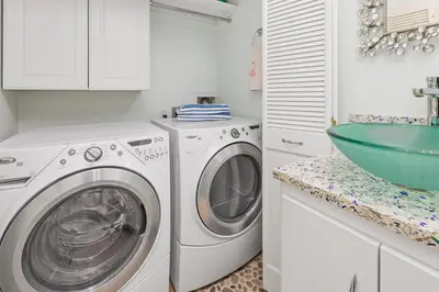 a white laundry room with a washing machine and a sink at Sea Forever - DMST3536 in Solana Beach