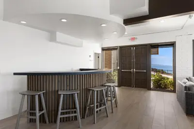 a kitchen with a bar and stools in a room at Sea Forever - DMST3536 in Solana Beach