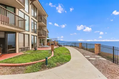 a walkway in front of a building next to the ocean at Sea Forever - DMST3536 in Solana Beach