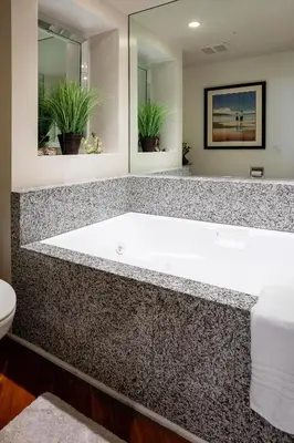 a bathroom with a large tub and a toilet at Sea-renity - DMST79 in Solana Beach