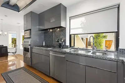 a kitchen with stainless steel appliances and a window at Coastal Soul - ENC656N in Encinitas