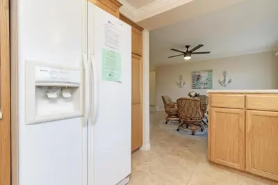 a kitchen with a refrigerator and a dining room at Sea'Esta by the Shore-DMBC852S in Solana Beach