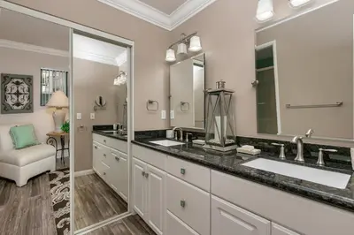 a bathroom with two sinks and a large mirror at A Wave From It All - SUR42 in Solana Beach