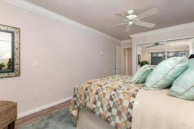 a bedroom with a bed with a ceiling fan at A Wave From It All - SUR42 in Solana Beach