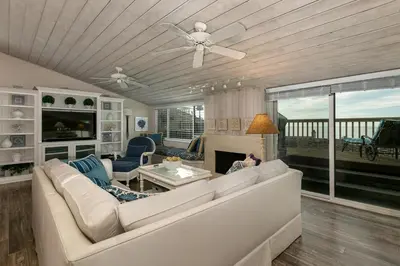 a living room with a white couch and a fireplace at A Wave From It All - SUR42 in Solana Beach
