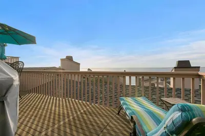 a deck with a hammock and an umbrella at A Wave From It All - SUR42 in Solana Beach