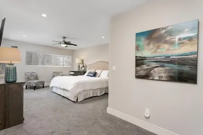 a bedroom with a bed and a painting on the wall at Endless Summer - SUR149 in Solana Beach