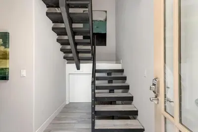 a staircase in a house with wooden floors at Endless Summer - SUR149 in Solana Beach