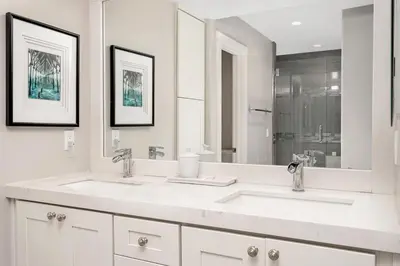 a white bathroom with two sinks and a mirror at Endless Summer - SUR149 in Solana Beach