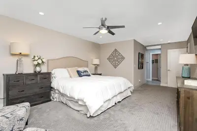 a bedroom with a bed and a ceiling fan at Endless Summer - SUR149 in Solana Beach