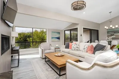a living room with a couch and a table at Endless Summer - SUR149 in Solana Beach