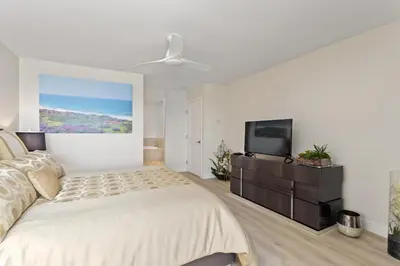 a bedroom with a bed and a flat screen tv at Don't Worry Beach Happy SONG13 in Solana Beach