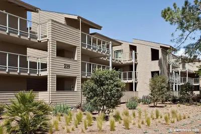 an apartment building with trees in front of it at Don't Worry Beach Happy SONG13 in Solana Beach