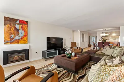 a living room with a couch and a fireplace at Don't Worry Beach Happy SONG13 in Solana Beach