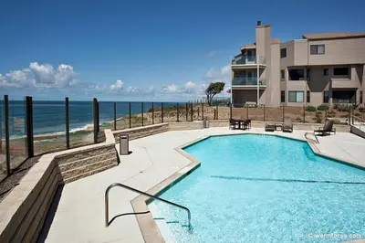 a swimming pool with a view of the ocean at Don't Worry Beach Happy SONG13 in Solana Beach