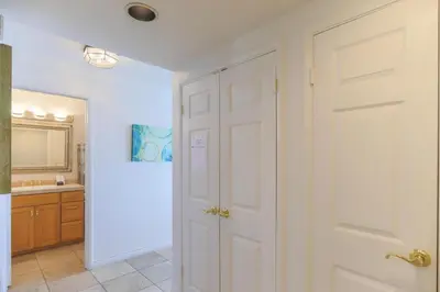 a bathroom with a white door and a sink at A Shore Thing! - DMST21 in Solana Beach