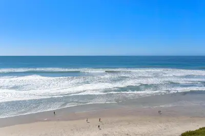 people standing on the beach near the ocean at Beach View Beauty - DMBC775D in Solana Beach