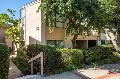 a building with bushes in front of a building at Escape at Seascape - SUR112 in Solana Beach