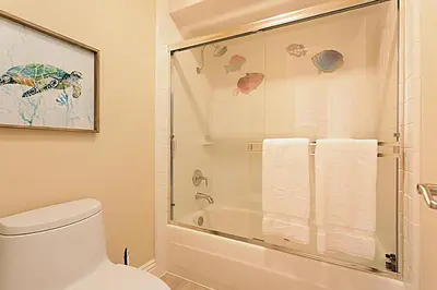 a bathroom with a toilet and a glass shower at Beach You To It! - SUR61 in Solana Beach