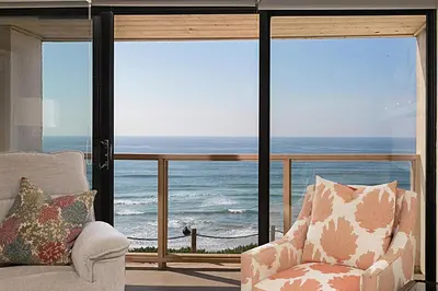 a living room with a view of the ocean at Beach You To It! - SUR61 in Solana Beach