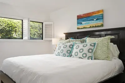 a bedroom with a white bed with pillows at Pacific Perch - SUR115S in Solana Beach