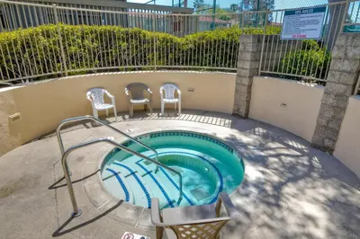 a swimming pool with two chairs and a table at Ocean Dreams - SBTC145 in Solana Beach