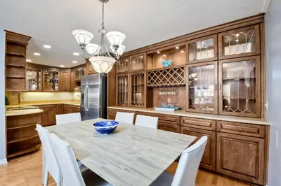 a kitchen with a table and chairs and a refrigerator at Ocean Dreams - SBTC145 in Solana Beach