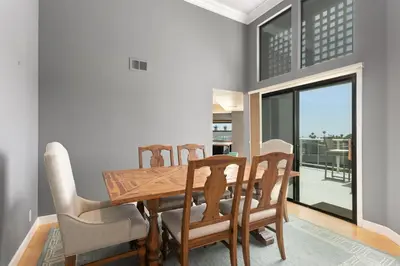 a dining room with a wooden table and chairs at Vista Pacific - DM1050 in Del Mar